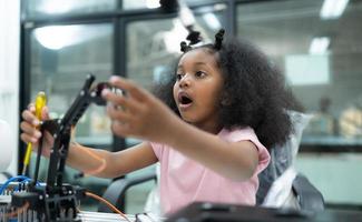 Youngsters utilizing the hand robot technology are having fun learning the electronic circuit board of hand robot technology, which is one of the STEM courses. photo