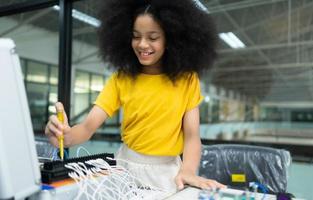 Youngsters utilizing the hand robot technology are having fun learning the electronic circuit board of hand robot technology, which is one of the STEM courses. photo