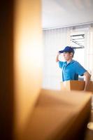 The delivery man brings the goods that the customer purchased and delivers them to the customer's home. photo