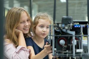 Children using the hand robot technology and having fun Learning the electronic circuit board of hand robot technology, which is one of the STEM courses. photo