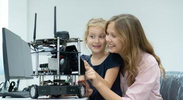 Children using the hand robot technology and having fun Learning the electronic circuit board of hand robot technology, which is one of the STEM courses. photo