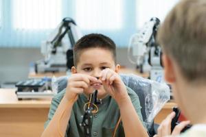 Children using the hand robot technology, Students are studying technology, which is one of the STEM courses. photo