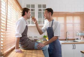 A young couple enters the kitchen to prepare dinner for celebrating the anniversary of being together for many years photo