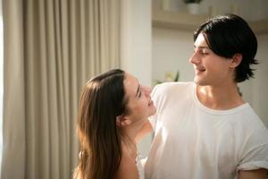 Young couple in the living room of the house in the morning, Dancing happily together photo