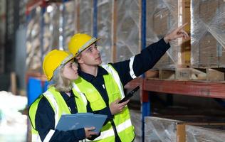 Both of employees in an auto parts warehouse, Examine auto parts that are ready to be shipped to the automobile assembly factory. photo