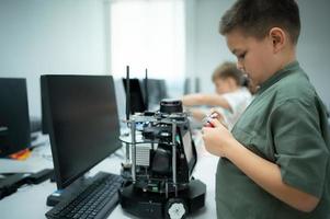 Youngsters utilizing the hand robot technology are having fun learning the hand robot controller of robot technology, which is one of the STEM courses. photo