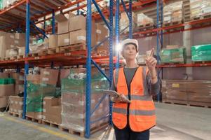 Portrait of warehouse supervisor in a large warehouse with their own preparation for the day's work photo