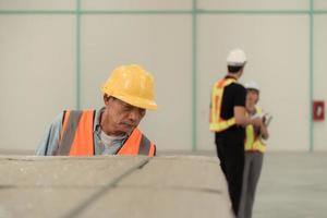Workers inspect the new warehouse's products. Use barcode scanners to check the products that will be used in the warehouse shelf structure. photo
