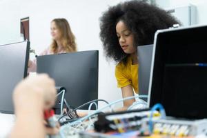 Youngsters utilizing the hand robot technology are having fun learning the electronic circuit board and hand robot controller of robot technology, which is one of the STEM courses. photo