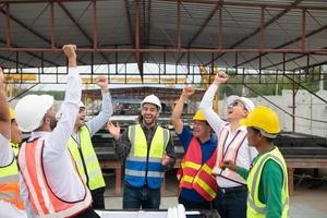 Construction engineers, architects, and foremen form a group. Participate in a meeting to plan new construction projects. Cheers to express happiness that the event was successfully accomplished. photo