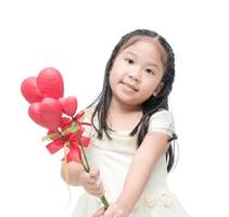 Cute asian little bridesmaid holding heart flower isolated photo