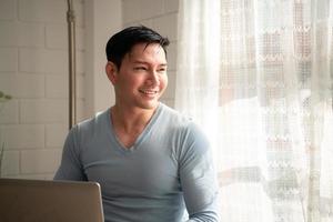 LGBT Young men use computers to communicate with their peers. on the days at home cannot go out. photo