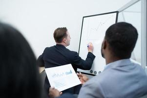 Businessmen with a meeting of the new management team with information comment finding common conclusions photo