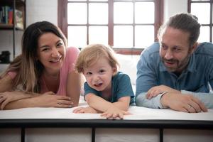 After the little boy wakes up from his nap, his father and mother engage in enjoyable activities in his bedroom. photo