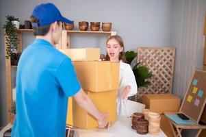 The delivery man brings the goods that the customer purchased and delivers them to the customer's home. photo