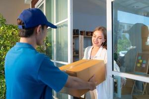 The delivery man brings the goods that the customer purchased and delivers them to the customer's home. photo