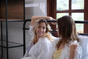 LGBT Young couple in the bedroom waking up in the morning sun with a cheerful mood. photo