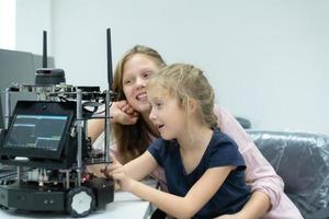 Children using the hand robot technology and having fun Learning the electronic circuit board of hand robot technology, which is one of the STEM courses. photo