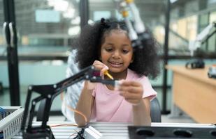 Youngsters utilizing the hand robot technology are having fun learning the electronic circuit board of hand robot technology, which is one of the STEM courses. photo