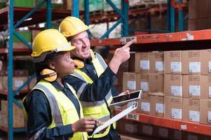 Warehouse foreman and employees Check the imported products in the central warehouse. before delivering to each region's distribution centers photo