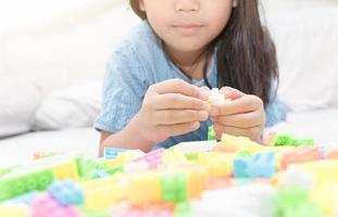 asian cute girl play block bricks on bed photo