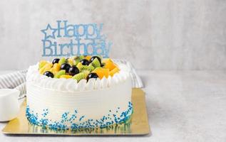 Mix fruits Kiwi orange and grape on cream cake, photo