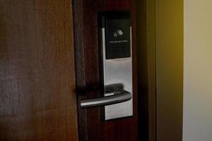 Outside the door that is installed with a key card door lock for hotels or general residences. It is an electronic door lock system that uses a card to open and close the door. photo