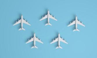 Different holiday or business trip destinations, airplanes on a blue background. photo