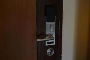 Inside the door that is equipped with a key card lock for hotels or general residences. It is an electronic door lock system that uses a card to open and close the door. Soft and selective focus. photo