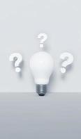 Innovation and new ideas concept. Question marks and a light bulb on white background. photo