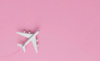 Airplanes on a pink background with Different holiday or business trip destinations. photo