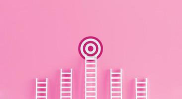 Target ladder achievement concept on blue wall studio background. photo