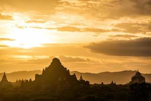 The sunset of Bagan, Myanmar is an ancient city with thousands of historic buddhist temples and stupas. photo