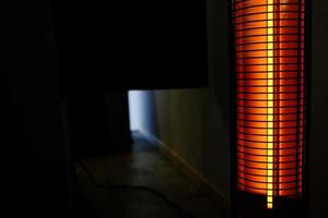 Portable Heater in the Dark Room with Space for Text. photo