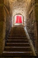 Old corridor with red curtain at the end. Concept for mystery, gothic, escape, hope. photo