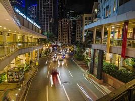 Night street scene from Eastwood neighborhood in Manila photo