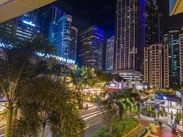 Night street scene from Eastwood neighborhood in Manila photo