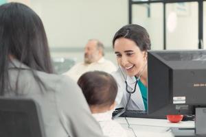 The pediatrician must try to play with the child. which parents brought to check the body to make it easier to examine the child photo