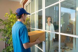 The delivery man brings the goods that the customer purchased and delivers them to the customer's home. photo