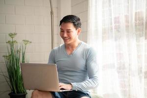 LGBT Young men use computers to communicate with their peers. on the days at home cannot go out. photo