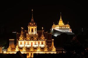 In the dark night, there was still a golden light in the central of Bangkok Thailand, The golden pagoda called the golden mountain temple, Tourist attractions that tourists visit to worship photo