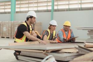 Meeting between designer and warehouse manager to organize the arrangement of product shelves in a huge, empty warehouse and investigating the solar panels that will be installed photo