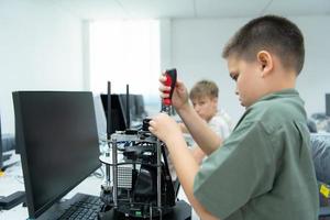 Youngsters utilizing the hand robot technology are having fun learning the hand robot controller of robot technology, which is one of the STEM courses. photo