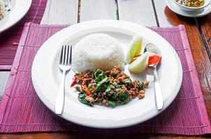 Thai stir-fried pork and basil served with rice photo