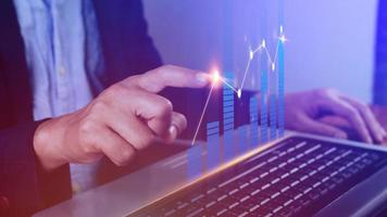 Businessman finger touch symbol stock graph and chart background, concept growth and development business investment, Stock market and strategy making market plan and stock market fluctuations photo