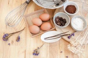 Top View Baking Preparation on wooden Table,Baking ingredients. Bowl, eggs and flour, rolling pin and eggshells on wooden board,Baking concept photo