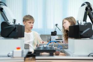 niños utilizando el mano robot tecnología, estudiantes son estudiando tecnología, cuales es uno de el vástago cursos foto