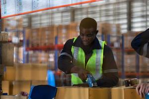 Group of worker in auto parts warehouse Packing small parts in boxes after inspecting the car parts that are ready to be sent to the car assembly plant. photo