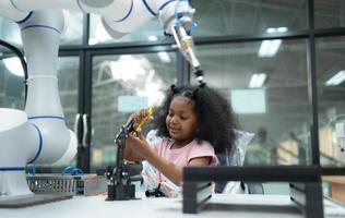 Youngsters utilizing the hand robot technology are having fun learning the electronic circuit board of hand robot technology, which is one of the STEM courses. photo