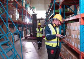 Warehouse foreman and employees Check the imported products in the central warehouse. before delivering to each region's distribution centers photo